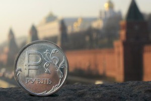 A Russian ruble coin is pictured in front of the Kremlin  ALEXANDER NEMENOV AFP