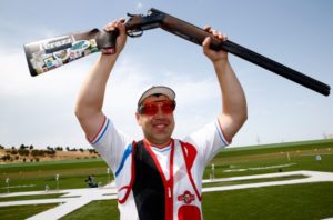 Russia's Alexey Alipov hoists his gun after winning the gold medal 