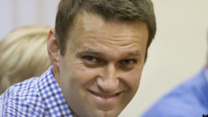 Russian opposition leader Alexei Navalny smiles as he listens to judge in a court in Kirov, Russia on Thursday, July 18, 2013. A Russian judge on Thursday found Navalny guilty of embezzlement, a finding that could bring the charismatic anti-corruption blogger and Moscow mayoral candidate up to six years in prison. (AP Photo/Evgeny Feldman)