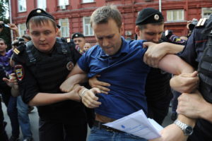 Police officers detain Russia's top opposition figure Alexei Navalny (C) after his visit the city's election commission office to submit documents to get registered as a mayoral election candidate in Moscow July 10, 2013. Police detained today  Navalny on a charge of organizing an unauthorized rally near the city's election commission office but later he was released. AFP PHOTO / VASILY MAXIMOV        (Photo credit should read VASILY MAXIMOV/AFP/Getty Images)